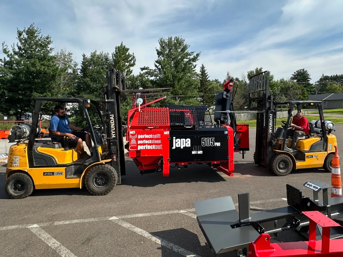 A forklift and a Japa firewood processor at Wolfe Ridge Manufacturing.