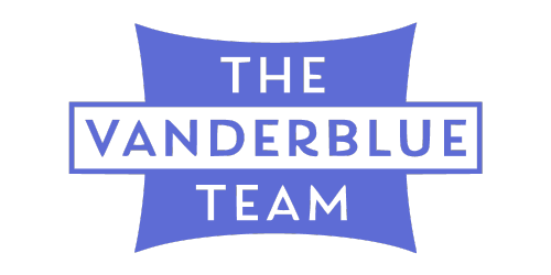 Logo of The Vanderblue Team, featuring white text with "THE" above "VANDERBLUE" against a dark blue background, and "TEAM" below it, all enclosed within a blue shield-like shape.