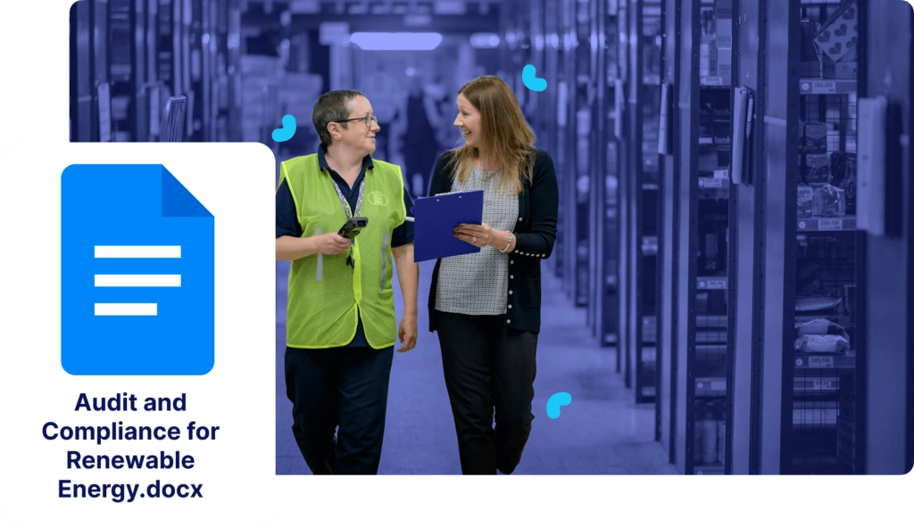 Two people walking and talking in a document storage area, discussing compliance. A digital icon displays the text "Audit and Compliance for Renewable Energy.docx" on the left.