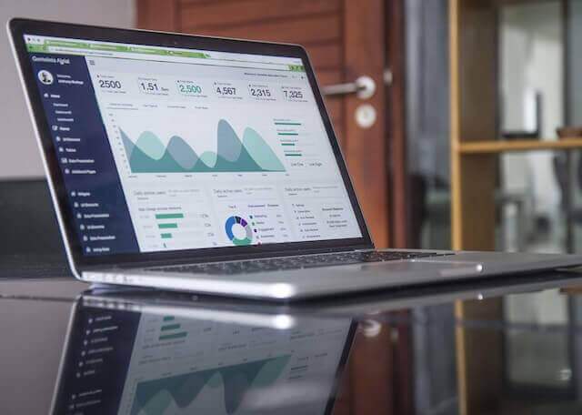 A laptop displaying a graph that is used for employee training and documentation purposes, placed on a table.