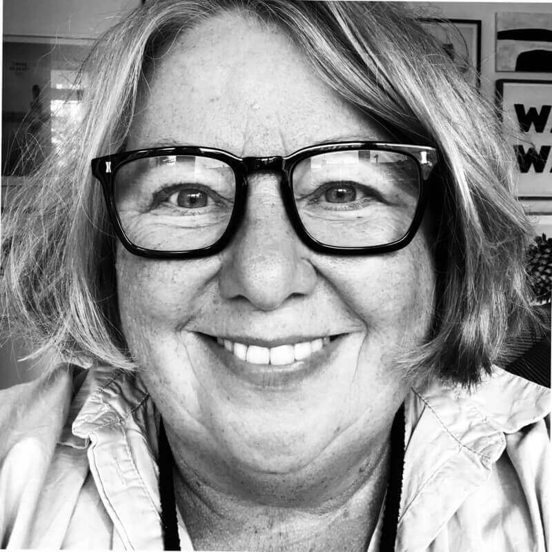 A monochrome image depicting a knowledgeable woman in glasses.