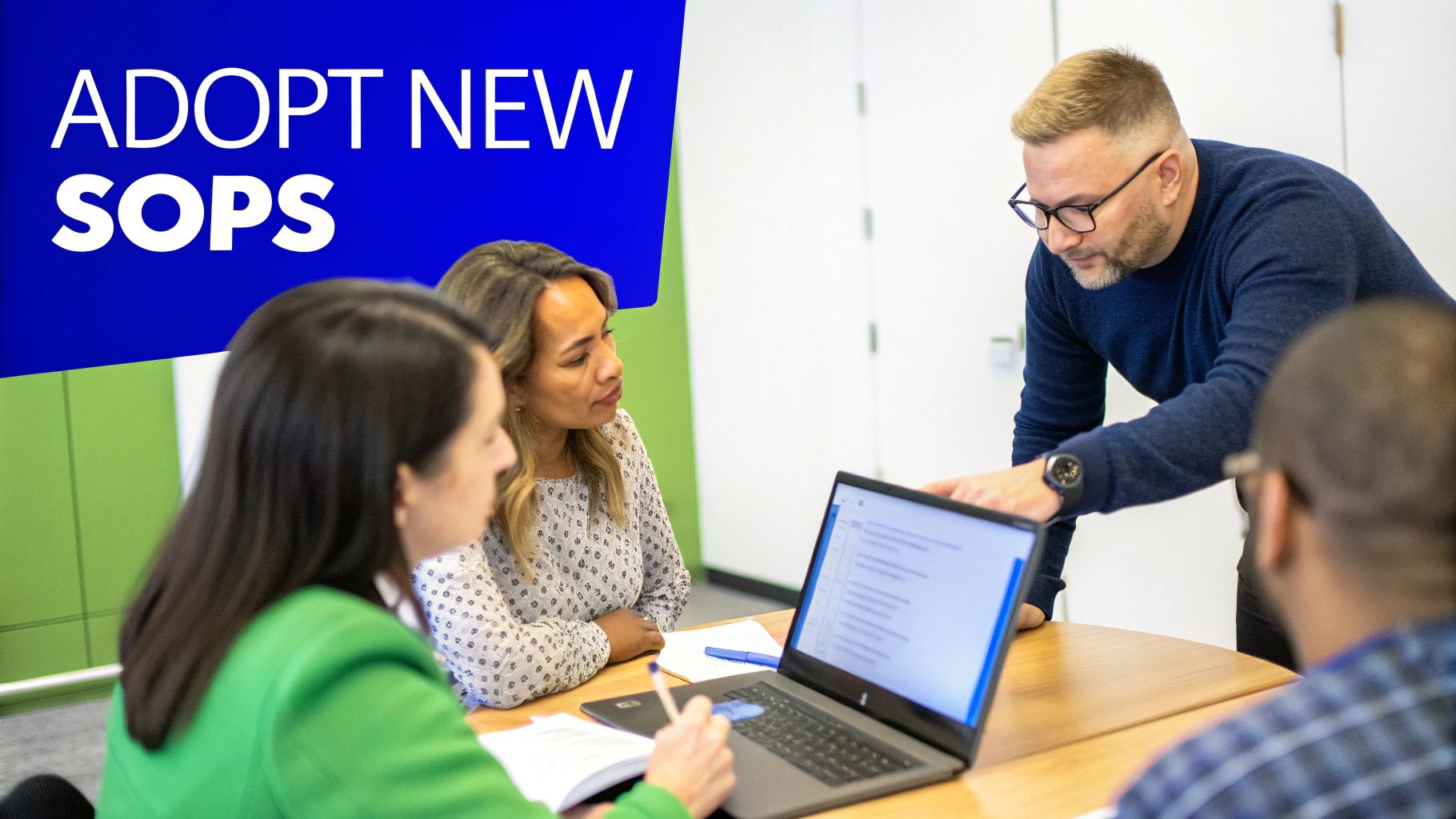 Four diverse colleagues collaborating on new SOPs with a laptop in a modern office.