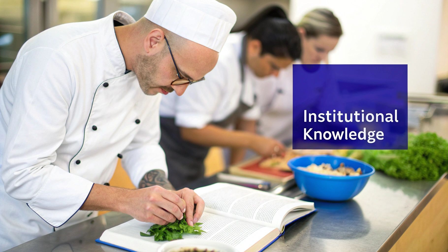 A chef in uniform reads a cookbook and prepares fresh herbs, demonstrating institutional knowledge in a kitchen.