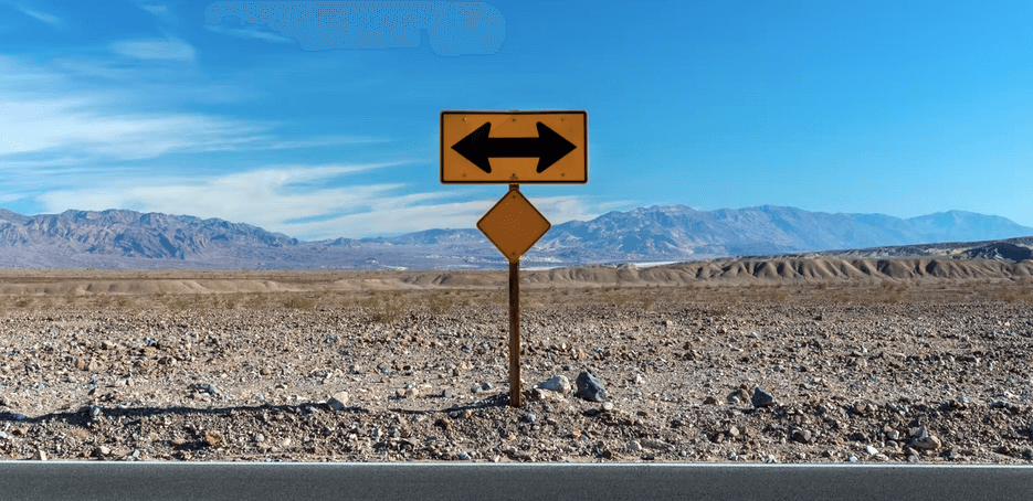 A road sign displaying SOP processes in the desert with mountains in the background.