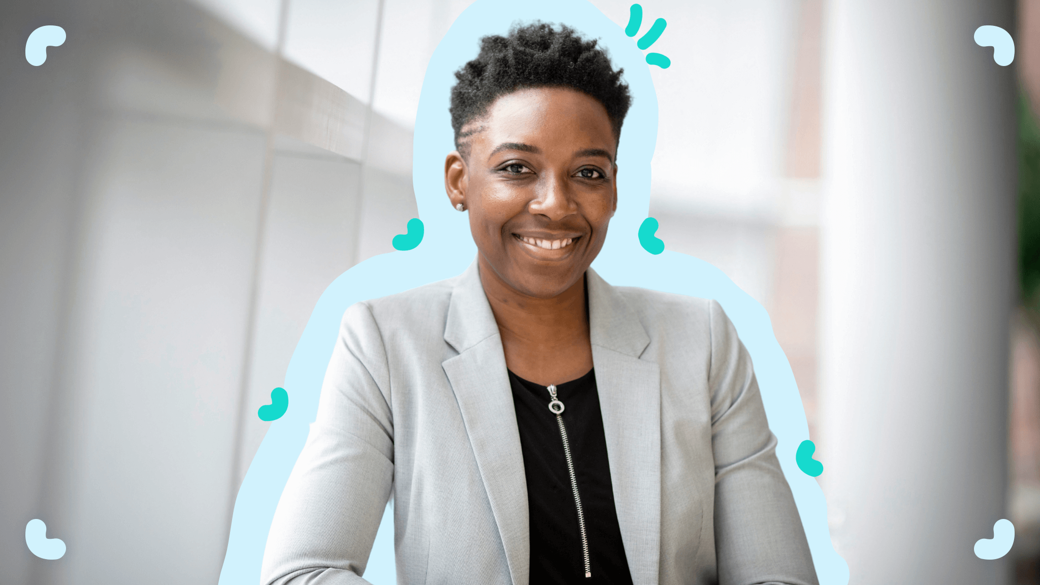 A woman smiling in front of a window, showcasing the importance of diversity and inclusion.