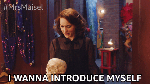 A woman holding a skull introducing herself to explain her knowledge and processes.