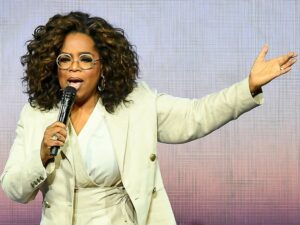Oprah Winfrey shares knowledge while speaking into a microphone.