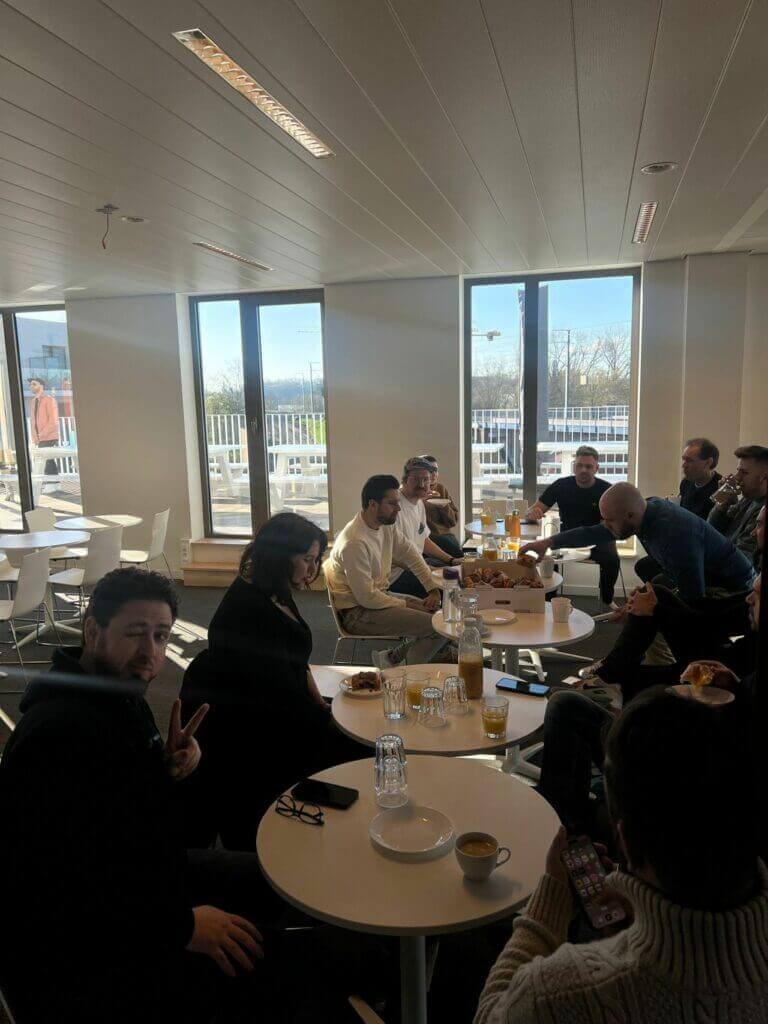 A Level 10 Meeting with a group of people sitting around a table in an office.