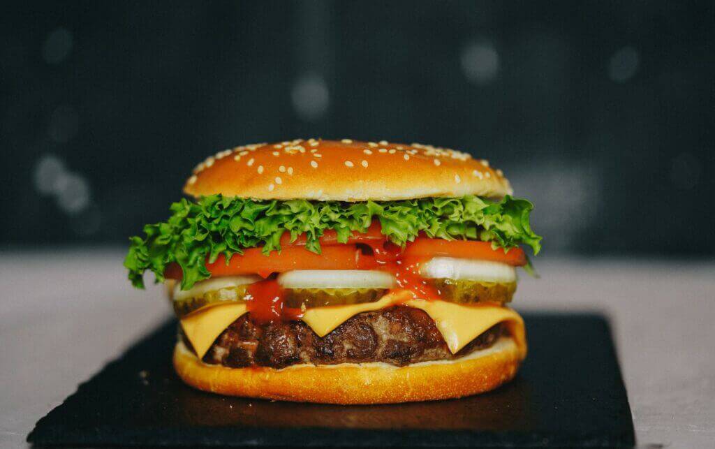 A hamburger is sitting on a plate.