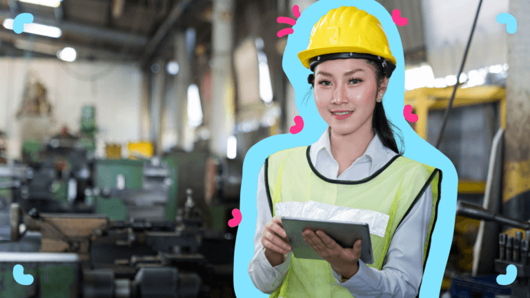 A woman in a hard hat holding a tablet with SOPs for digital transformation in a factory.