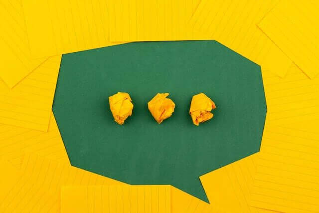 Three yellow crumpled pieces of paper containing SOPs and processes in a yellow speech bubble.