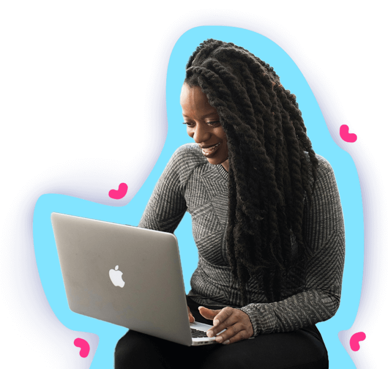 A woman with dreadlocks diligently working on her laptop, proficiently utilizing software applications to create comprehensive documentation in adherence to standard operating procedures for employee training.