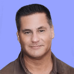 A man with short dark hair and a neutral expression poses against a plain blue background. He is wearing a brown collared shirt, ready for the onboarding process.